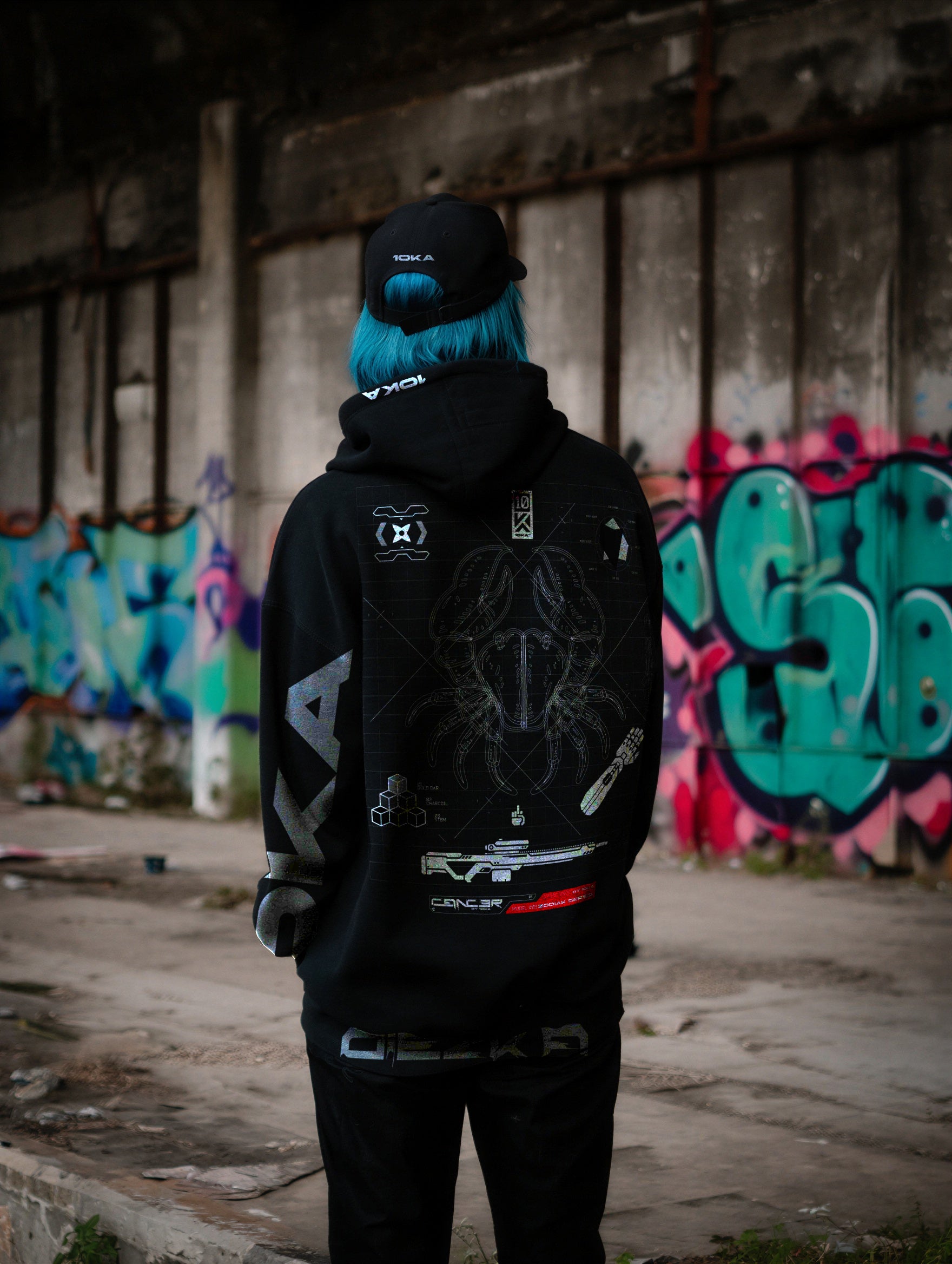 Lifestyle image of a person wearing the 10KA Zodiac Hoodie Cancer in an urban environment